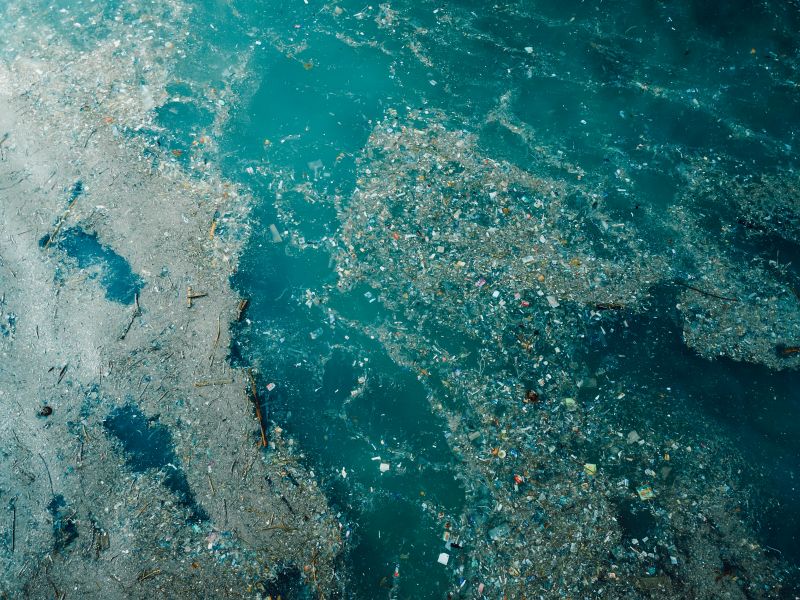 Indian ocean and plastic trash, aerial view. Pollution by plastic rubbish in Indonesia